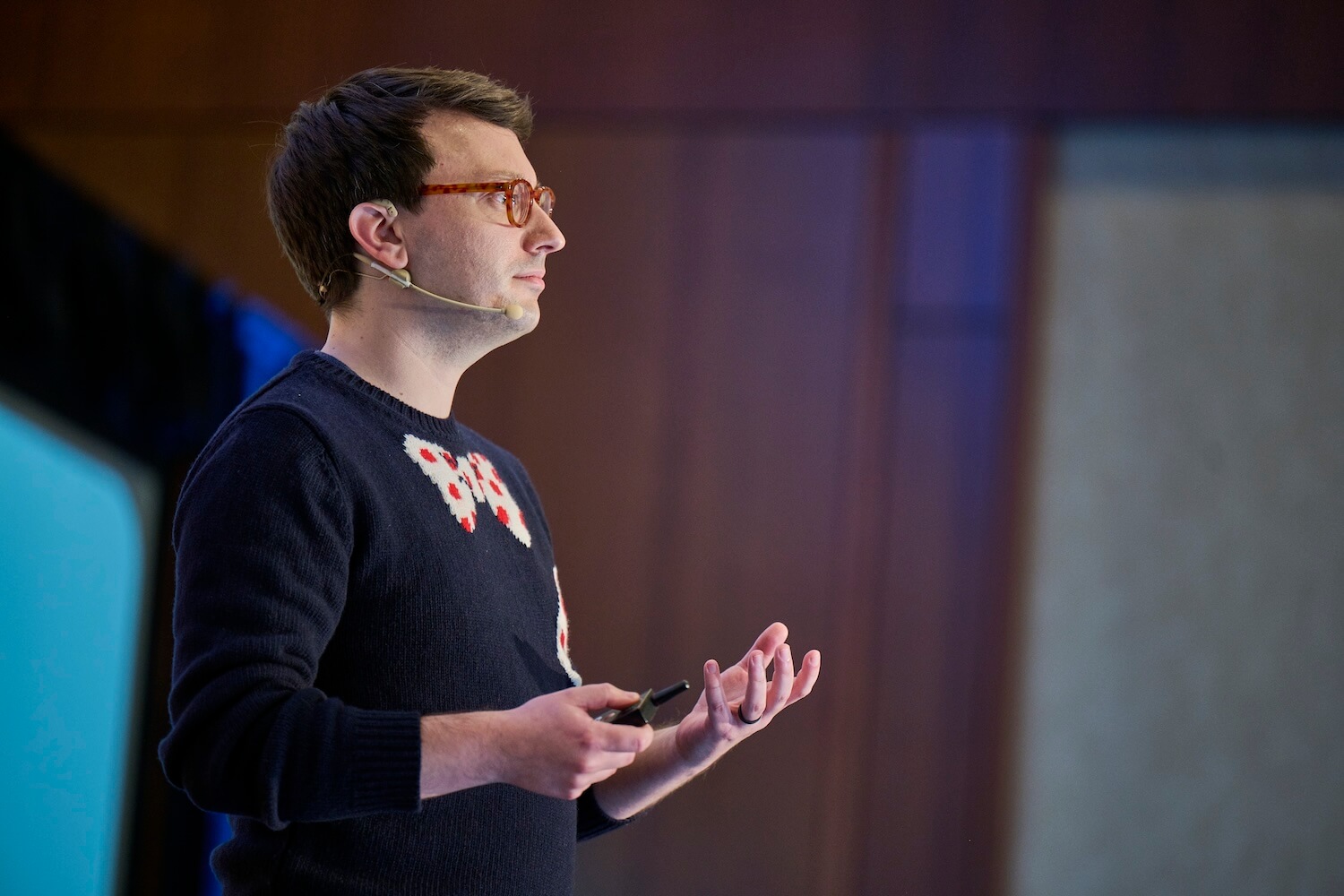 A photo of Matt speaking at a conference